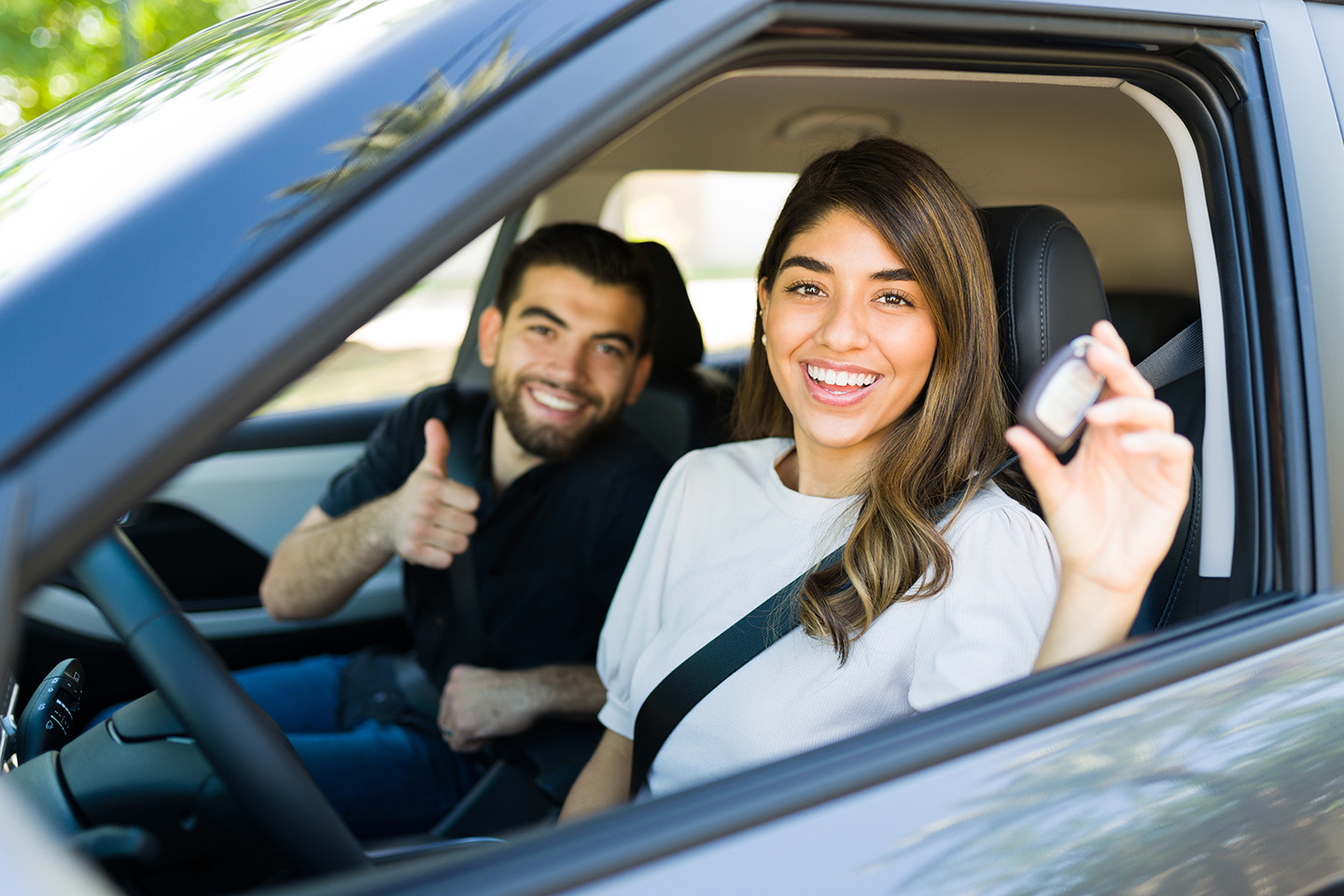 couple holding keys of new car