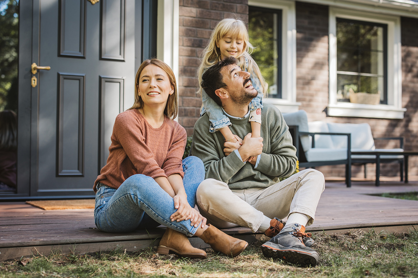 Family in front of house